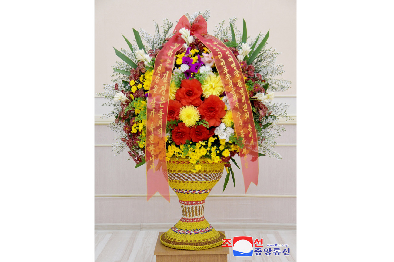 President of State Affairs Kim Jong Un receives floral basket from Lao President