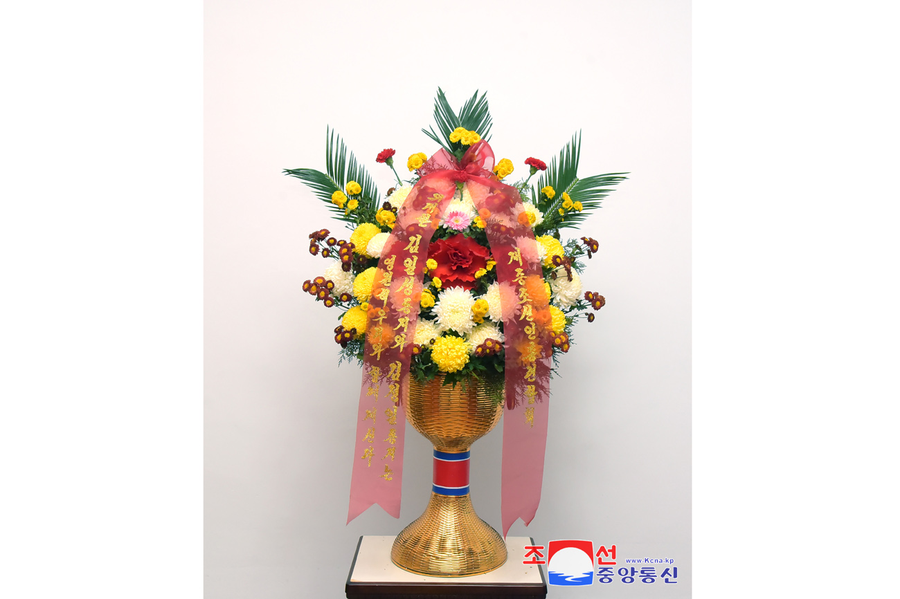 Floral baskets sent to bronze statues of great leaders Kim Il Sung and Kim Jong Il