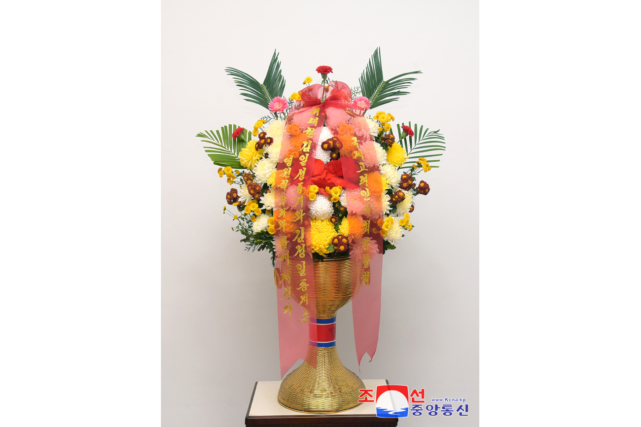 Floral baskets sent to bronze statues of great leaders Kim Il Sung and Kim Jong Il