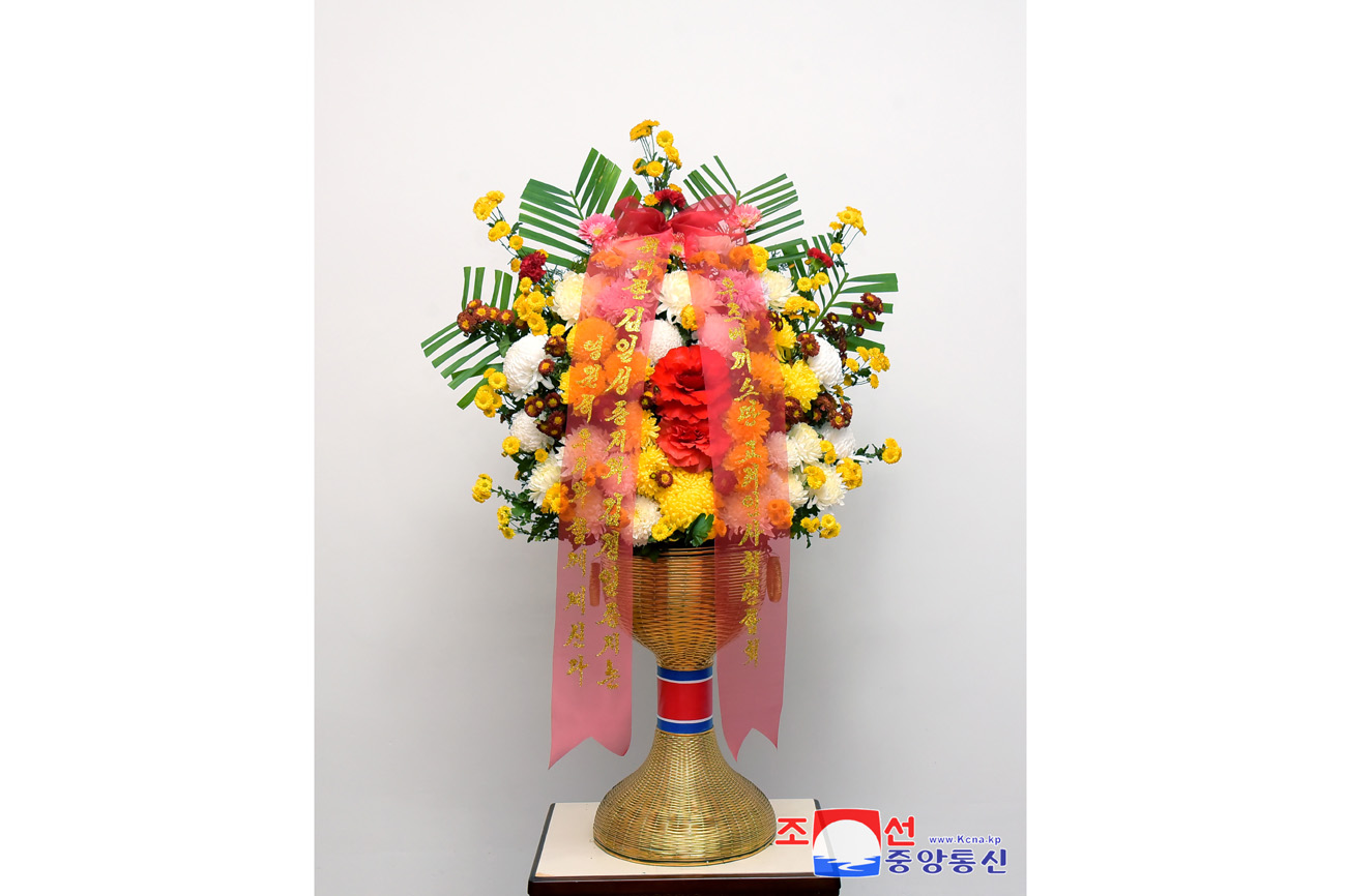 Floral baskets sent to bronze statues of great leaders Kim Il Sung and Kim Jong Il