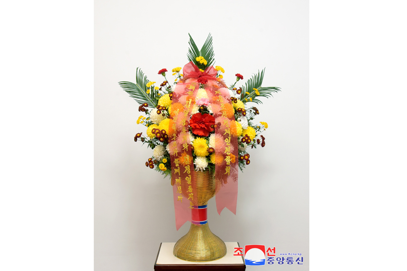 Floral baskets sent to bronze statues of great leaders Kim Il Sung and Kim Jong Il