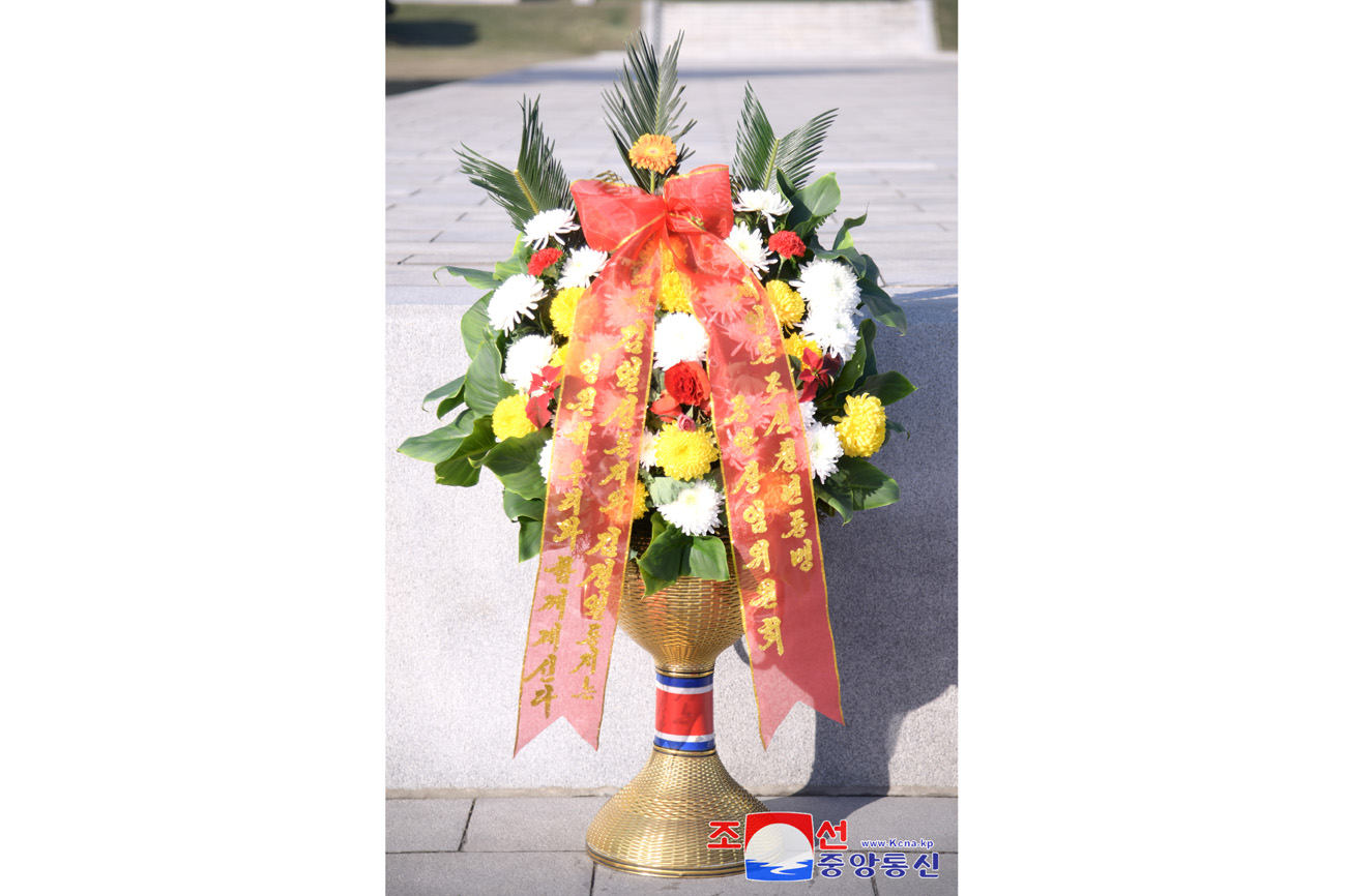 Floral baskets sent to bronze statues of great leaders Kim Il Sung and Kim Jong Il