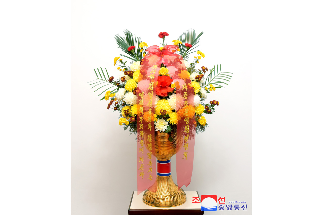 Floral baskets sent to bronze statues of great leaders Kim Il Sung and Kim Jong Il