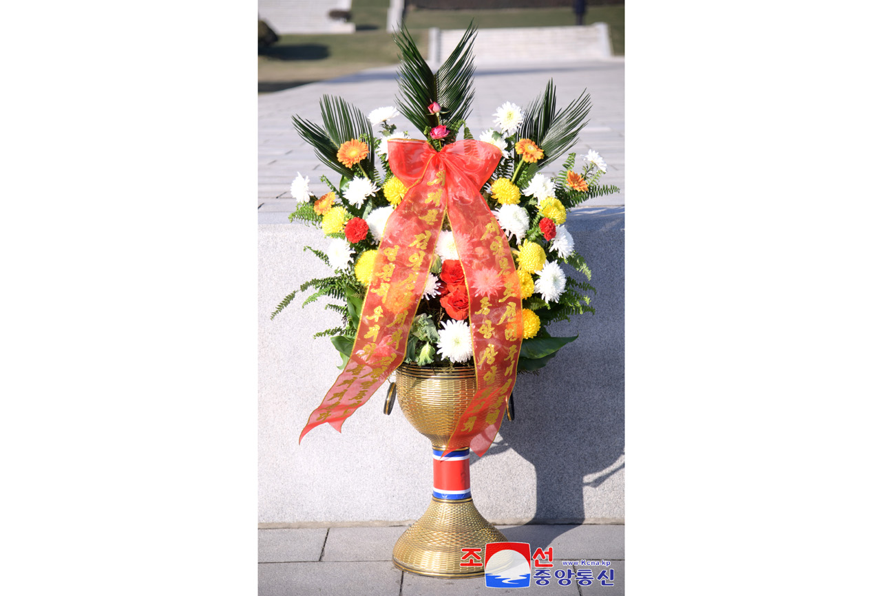 Floral baskets sent to bronze statues of great leaders Kim Il Sung and Kim Jong Il