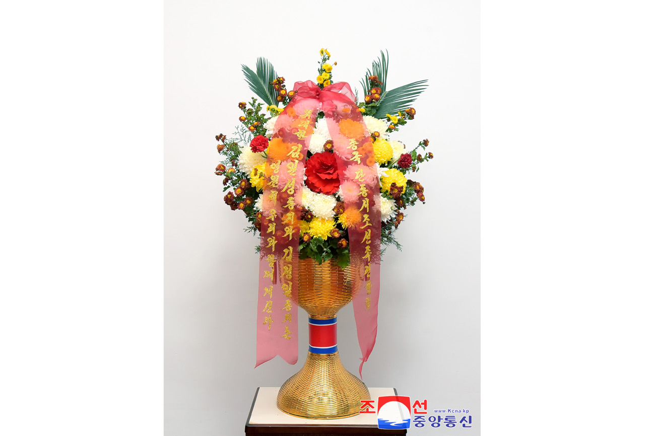 Floral baskets sent to bronze statues of great leaders Kim Il Sung and Kim Jong Il