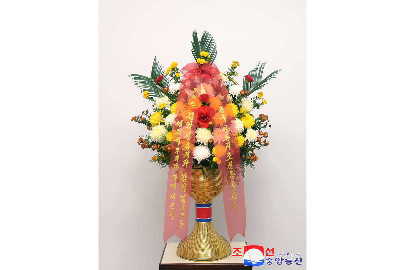 Floral baskets sent to bronze statues of great leaders Kim Il Sung and Kim Jong Il