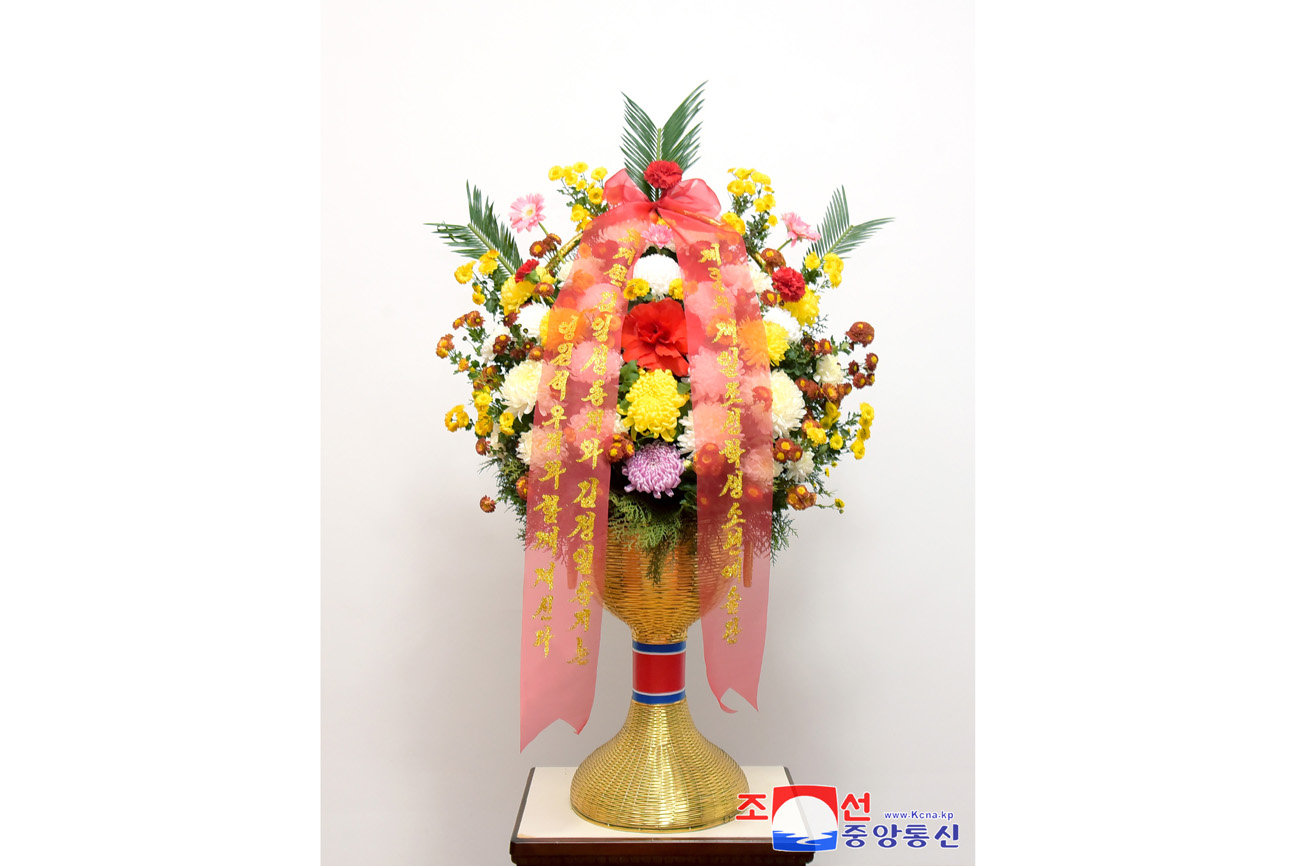 Floral baskets sent to bronze statues of great leaders Kim Il Sung and Kim Jong Il