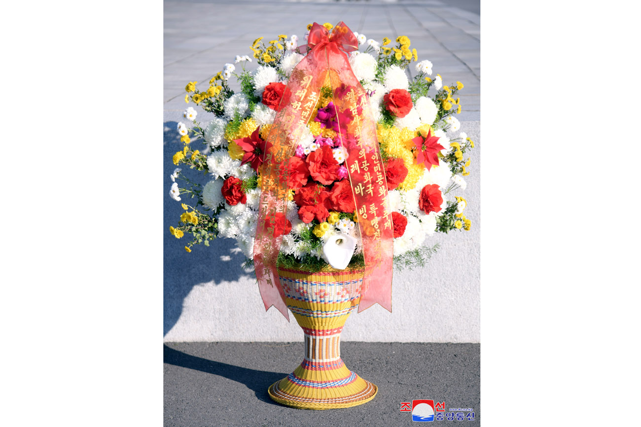 Floral baskets laid before bronze statues of great leaders Kim Il Sung and Kim Jong Il