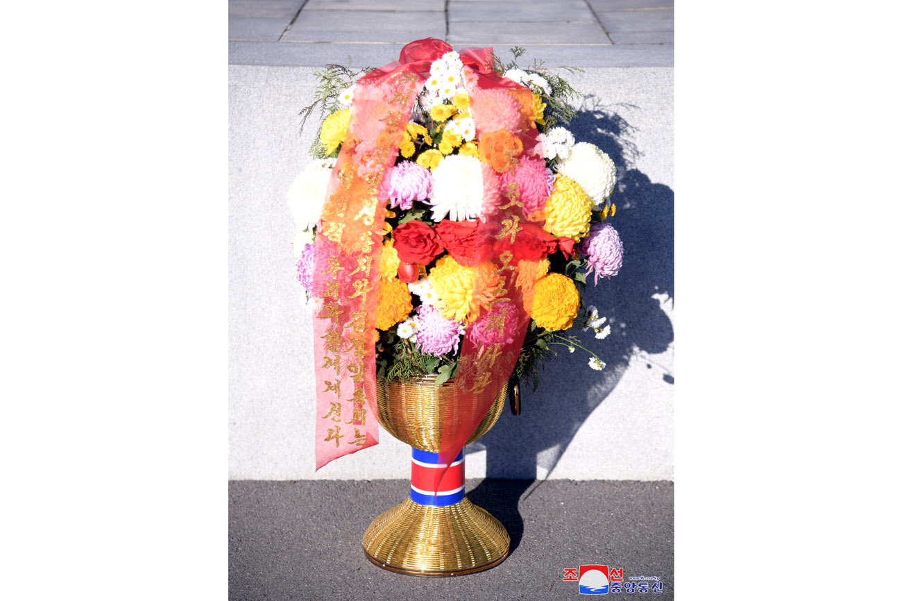 Floral baskets laid before bronze statues of great leaders Kim Il Sung and Kim Jong Il