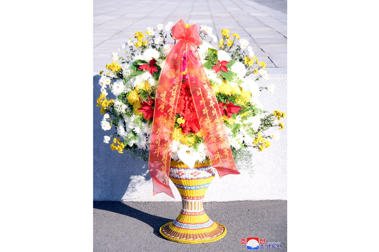 Floral baskets laid before bronze statues of great leaders Kim Il Sung and Kim Jong Il