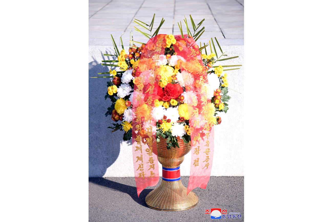 Floral baskets laid before bronze statues of great leaders Kim Il Sung and Kim Jong Il