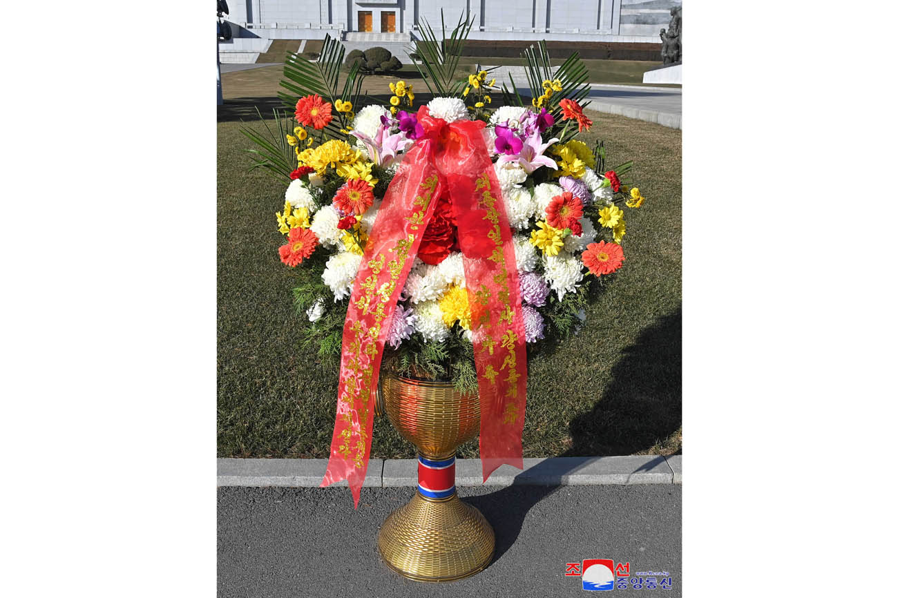 Floral baskets sent to bronze statues of great leaders Kim Il Sung and Kim Jong Il