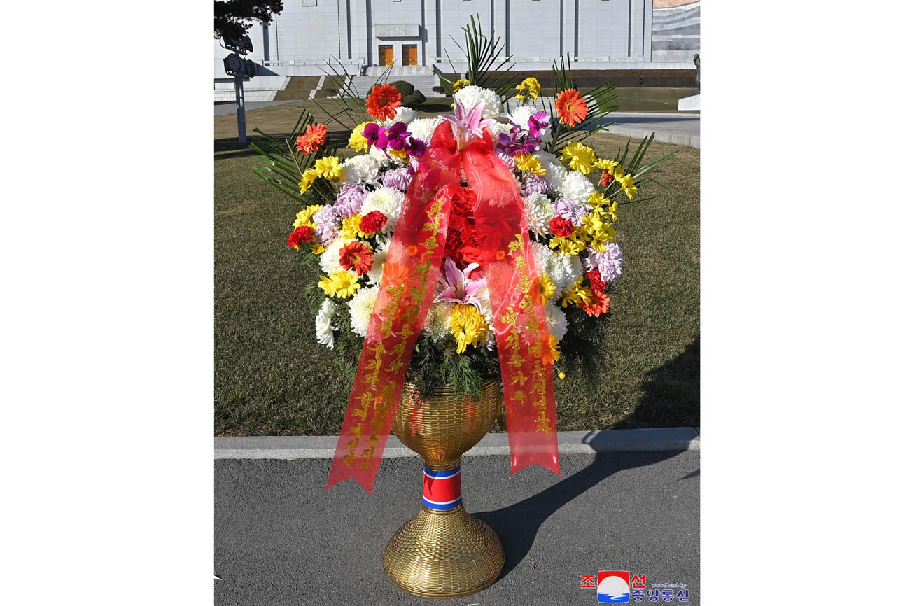 Floral baskets sent to bronze statues of great leaders Kim Il Sung and Kim Jong Il