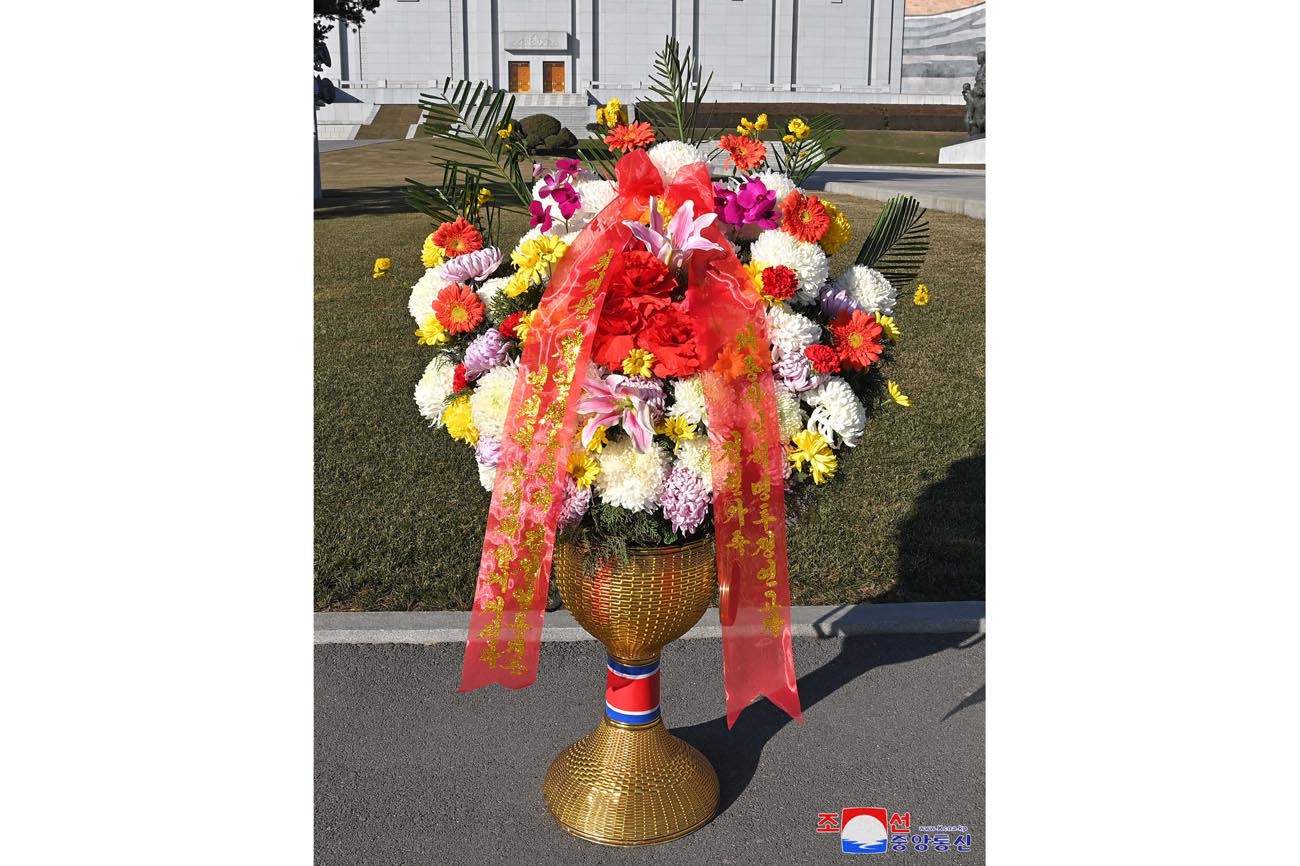 Floral baskets sent to bronze statues of great leaders Kim Il Sung and Kim Jong Il