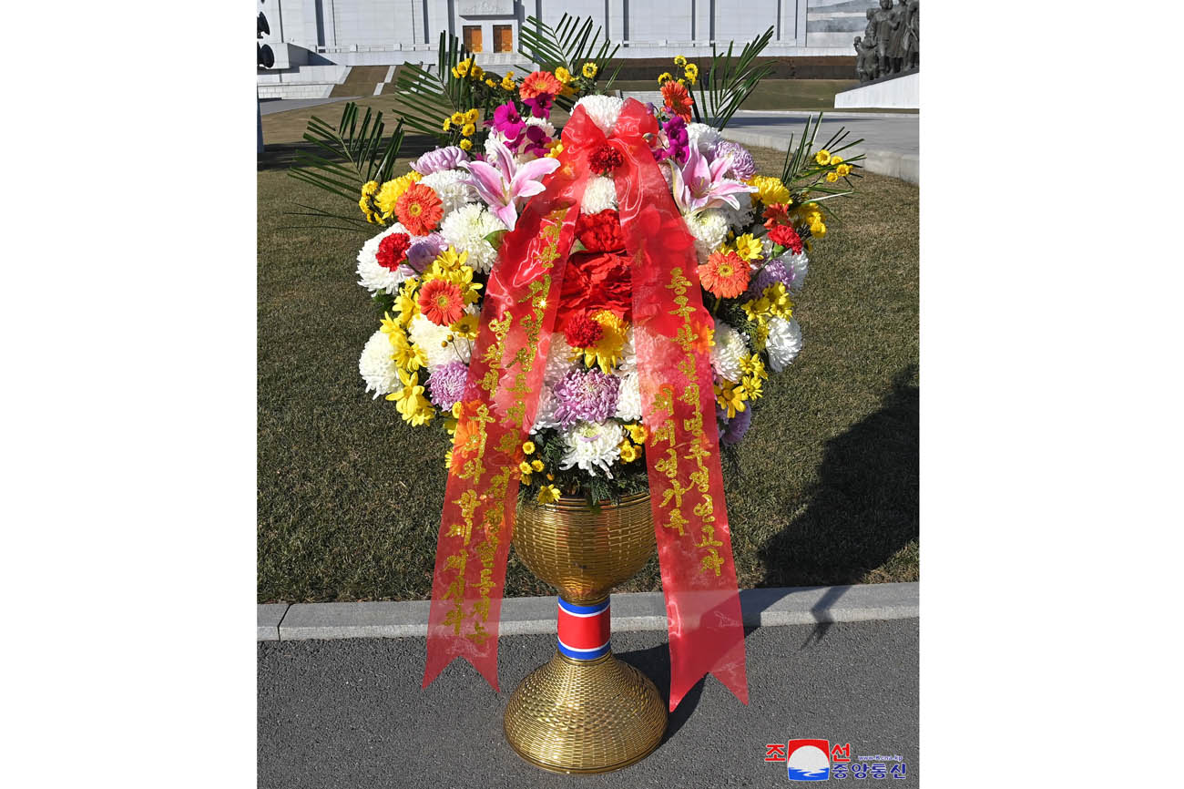 Floral baskets sent to bronze statues of great leaders Kim Il Sung and Kim Jong Il