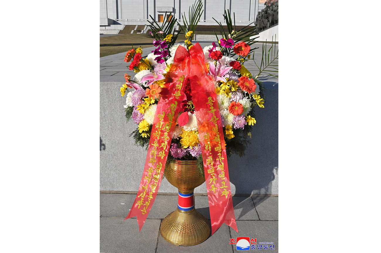 Floral baskets sent to bronze statues of great leaders Kim Il Sung and Kim Jong Il