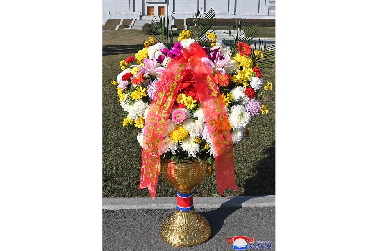 Floral baskets sent to bronze statues of great leaders Kim Il Sung and Kim Jong Il