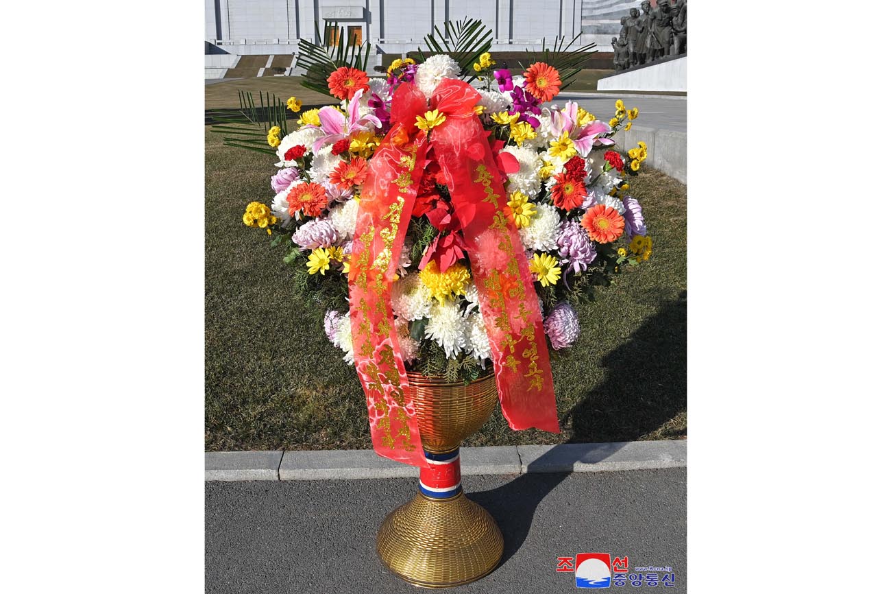 Floral baskets sent to bronze statues of great leaders Kim Il Sung and Kim Jong Il