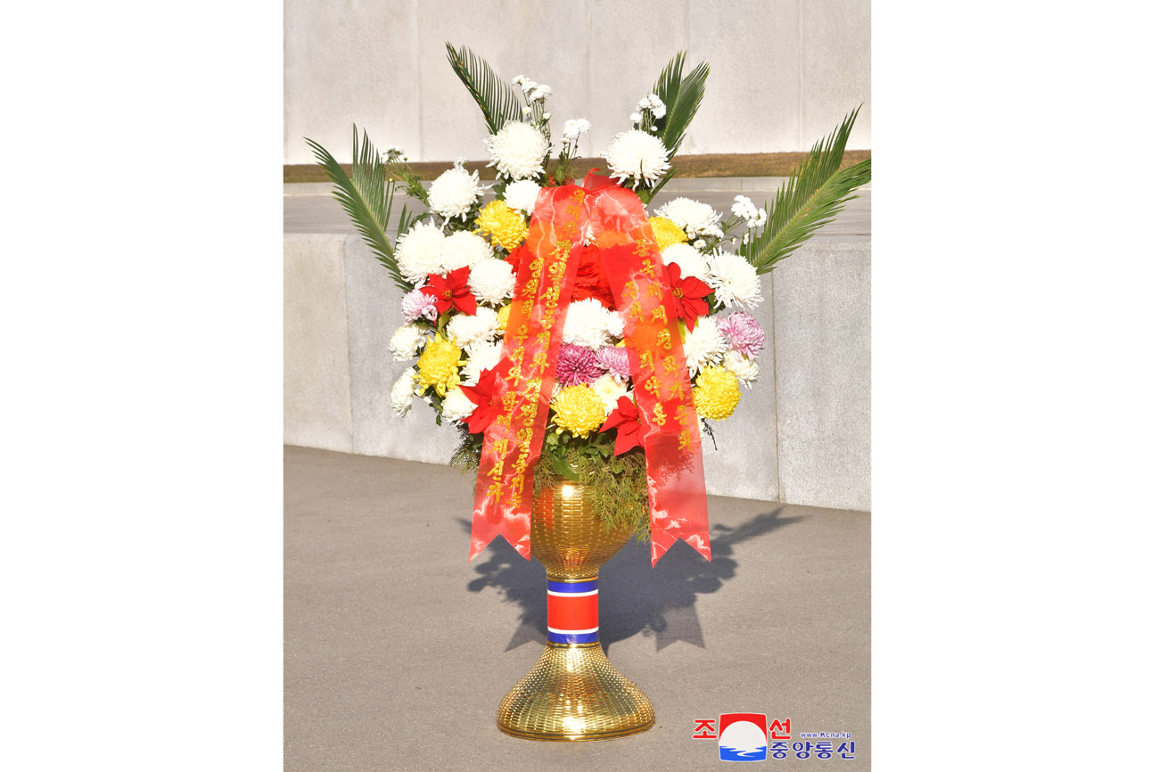 Floral baskets sent to bronze statues of great leaders Kim Il Sung and Kim Jong Il