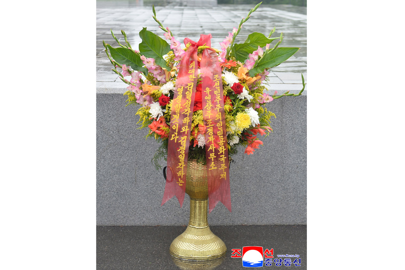 Floral baskets laid before bronze statues of great leaders Kim Il Sung and Kim Jong Il