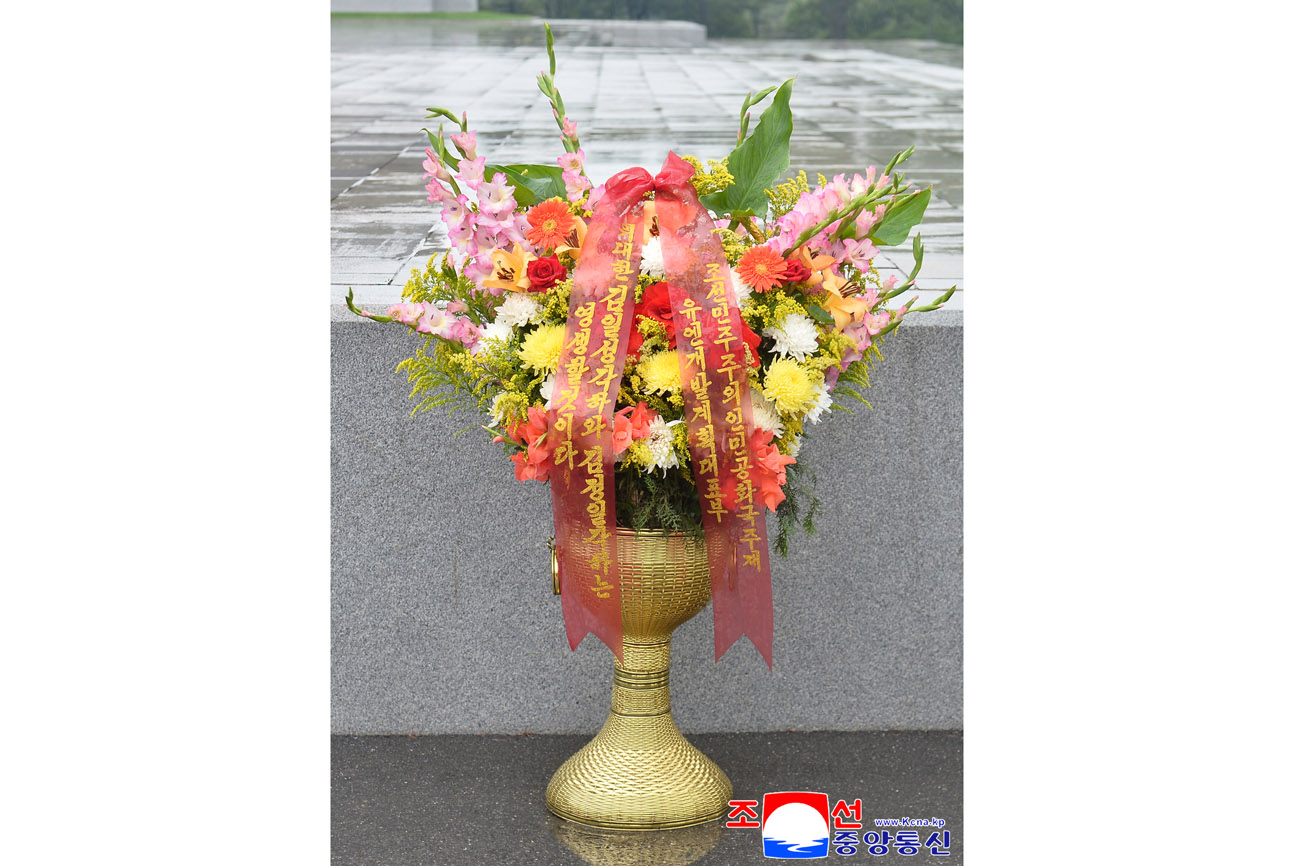 Floral baskets laid before bronze statues of great leaders Kim Il Sung and Kim Jong Il