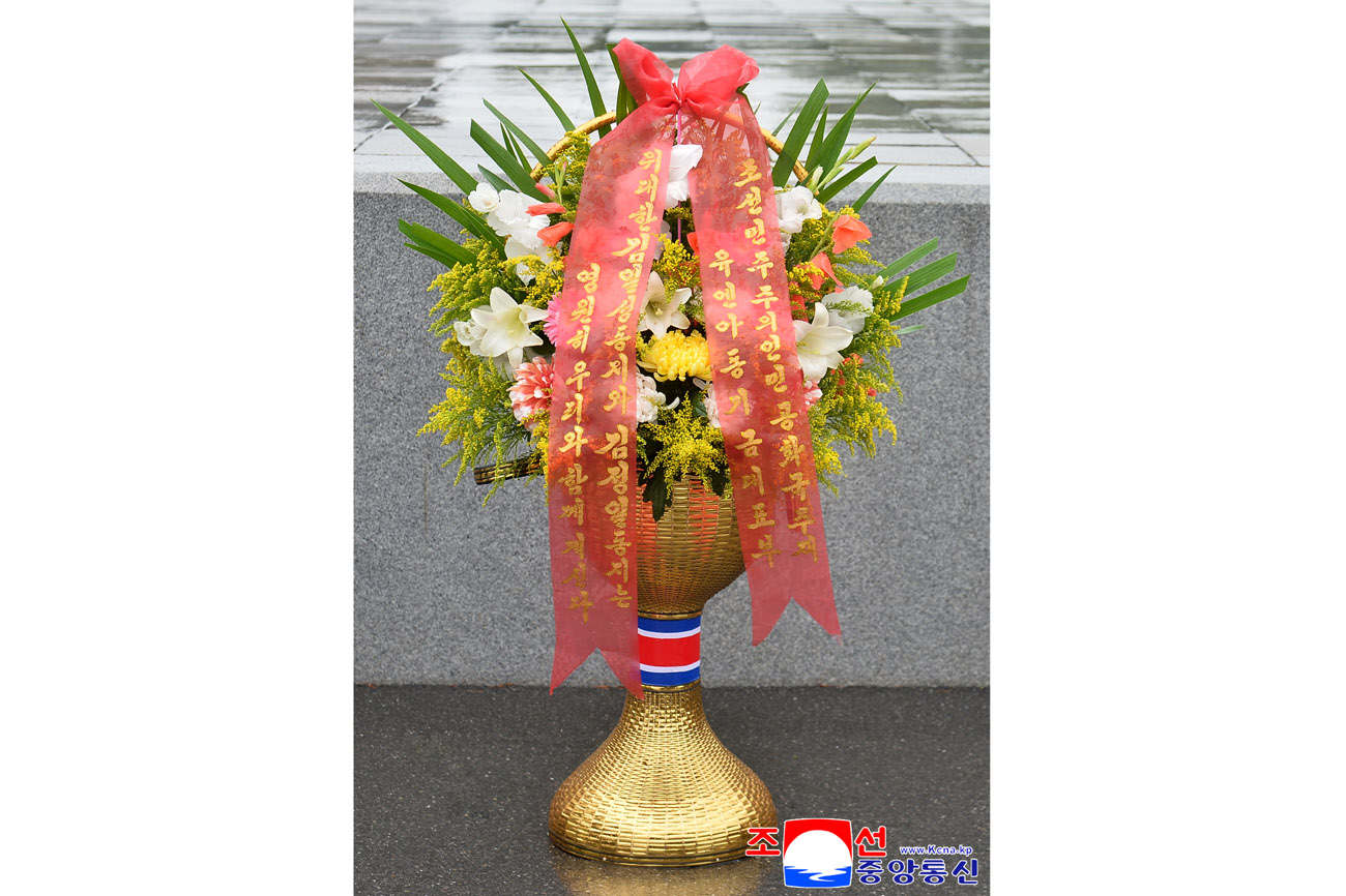 Floral baskets laid before bronze statues of great leaders Kim Il Sung and Kim Jong Il