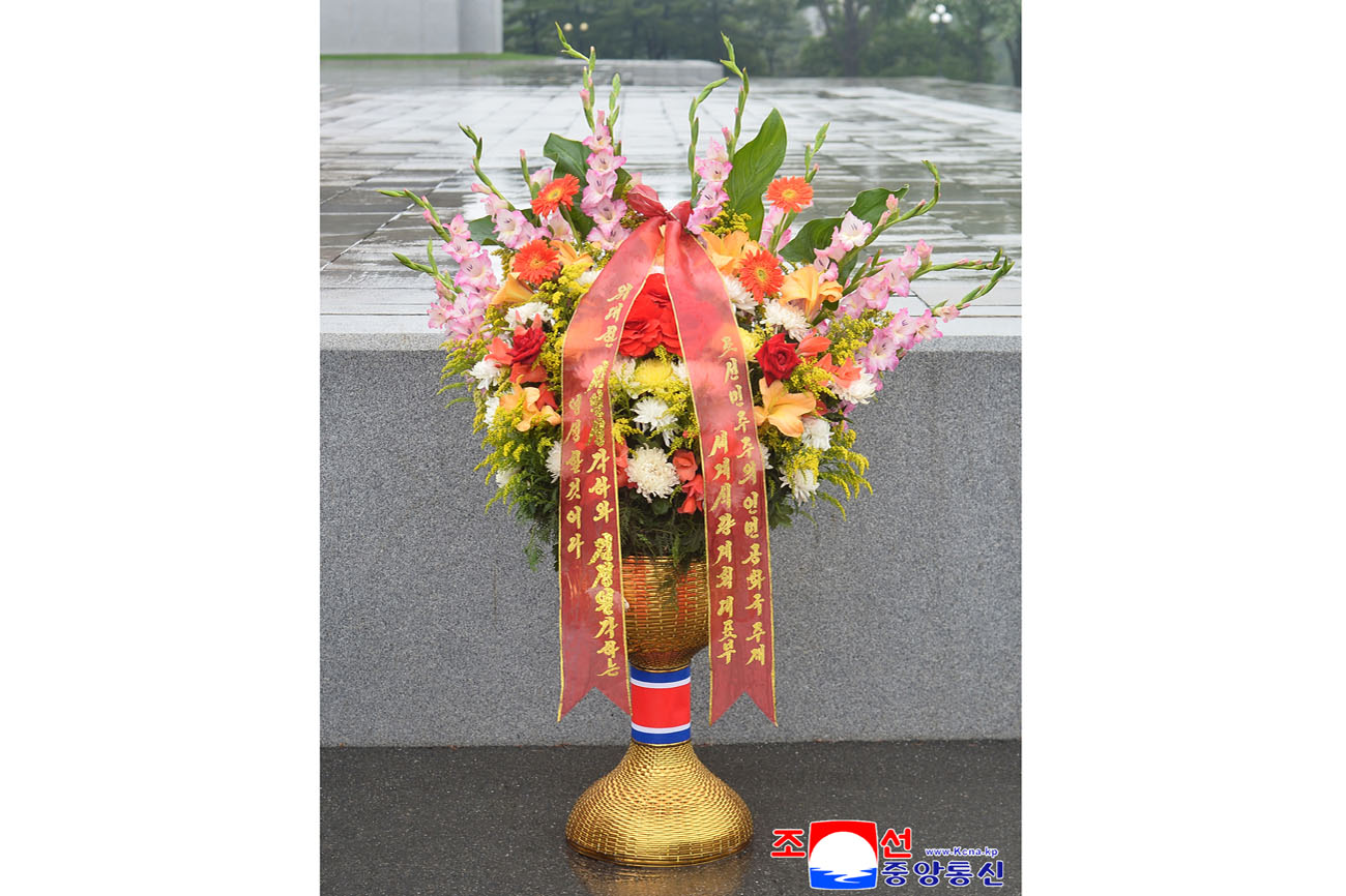 Floral baskets laid before bronze statues of great leaders Kim Il Sung and Kim Jong Il