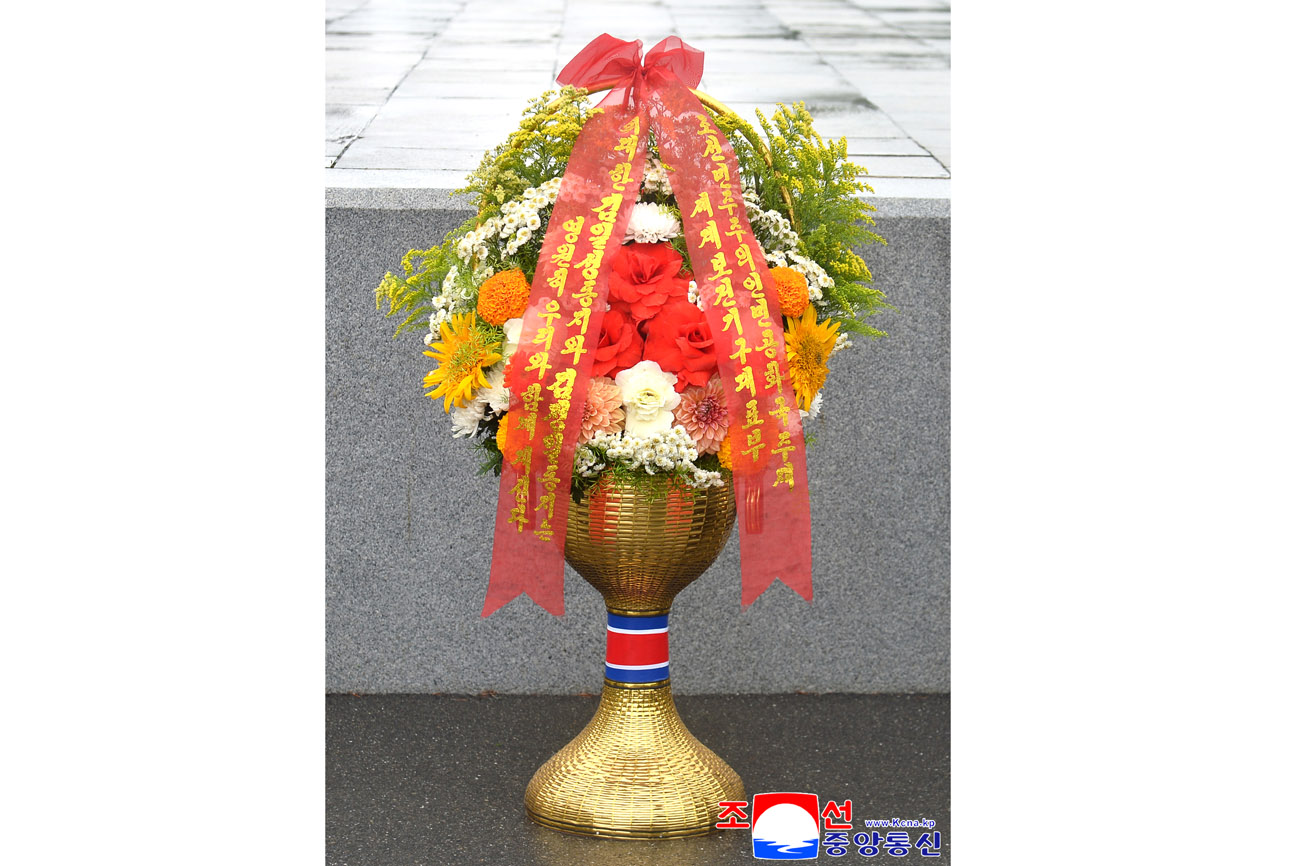 Floral baskets laid before bronze statues of great leaders Kim Il Sung and Kim Jong Il