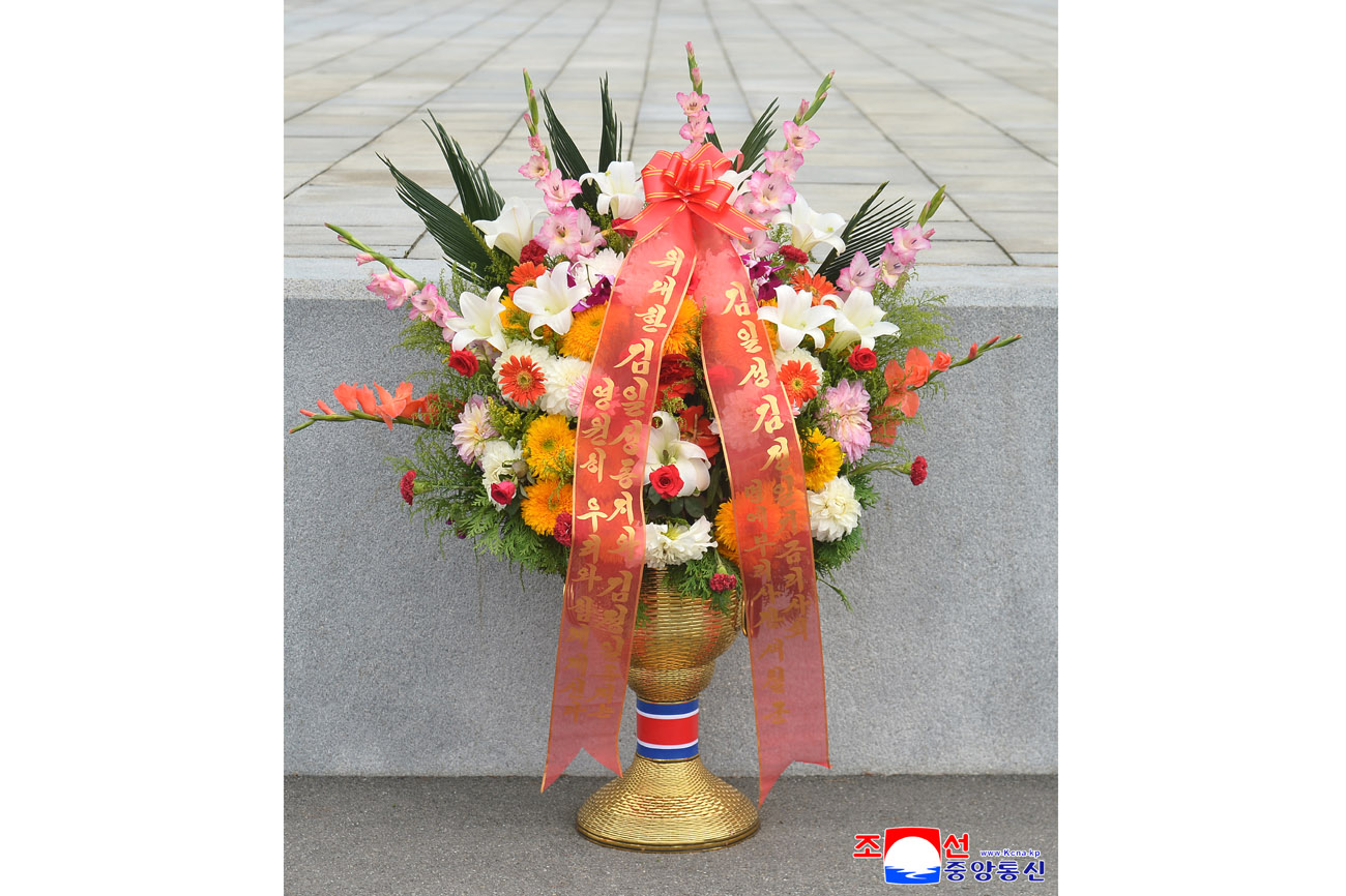 Floral baskets sent to bronze statues of great leaders Kim Il Sung and Kim Jong Il