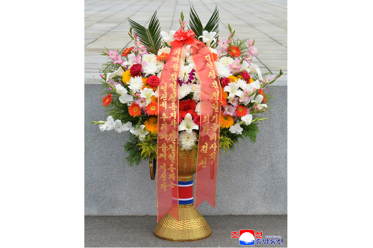 Floral baskets sent to bronze statues of great leaders Kim Il Sung and Kim Jong Il