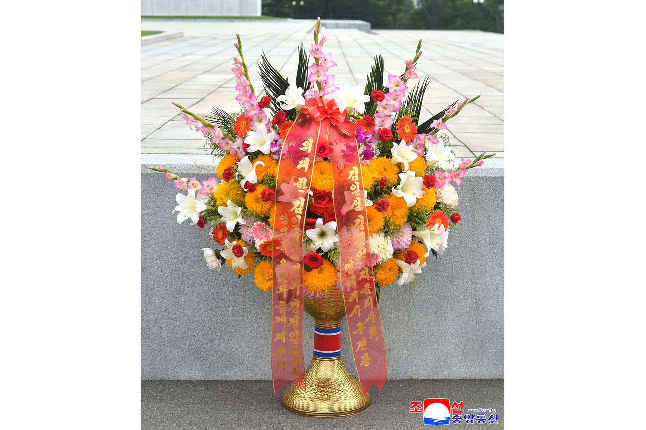 Floral baskets sent to bronze statues of great leaders Kim Il Sung and Kim Jong Il