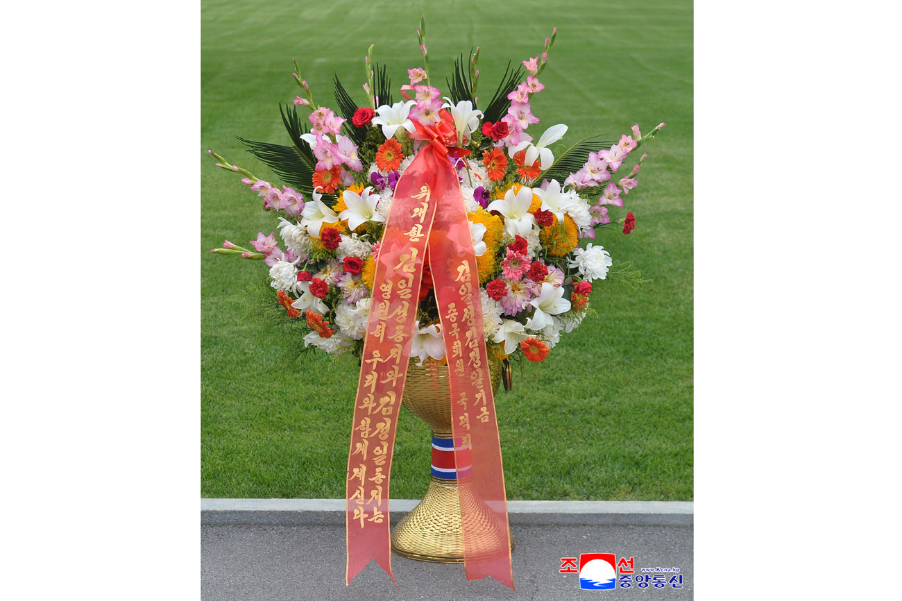 Floral baskets sent to bronze statues of great leaders Kim Il Sung and Kim Jong Il