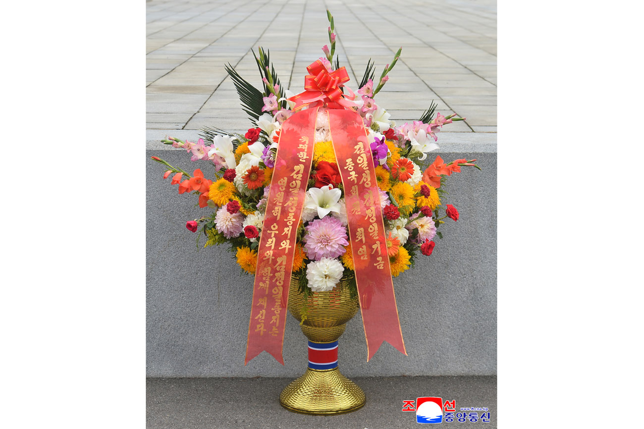 Floral baskets sent to bronze statues of great leaders Kim Il Sung and Kim Jong Il