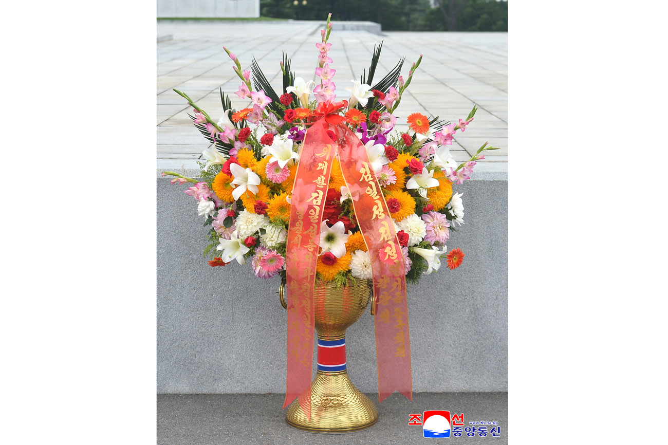 Floral baskets sent to bronze statues of great leaders Kim Il Sung and Kim Jong Il