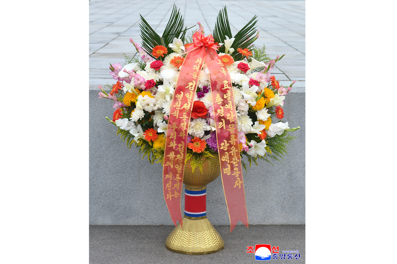 Floral baskets sent to bronze statues of great leaders Kim Il Sung and Kim Jong Il
