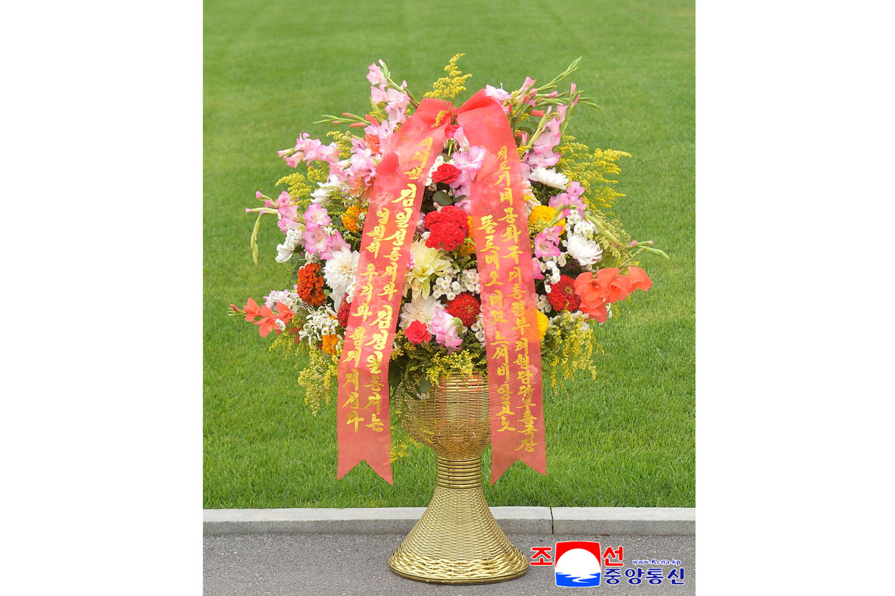 Floral baskets sent to bronze statues of great leaders Kim Il Sung and Kim Jong Il