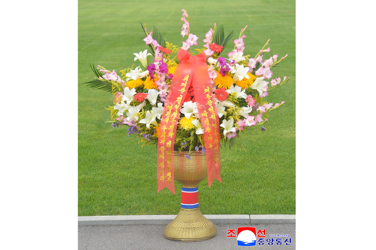 Floral baskets sent to bronze statues of great leaders Kim Il Sung and Kim Jong Il