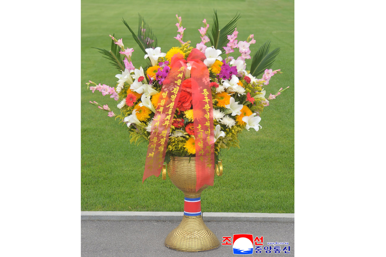 Floral baskets sent to bronze statues of great leaders Kim Il Sung and Kim Jong Il