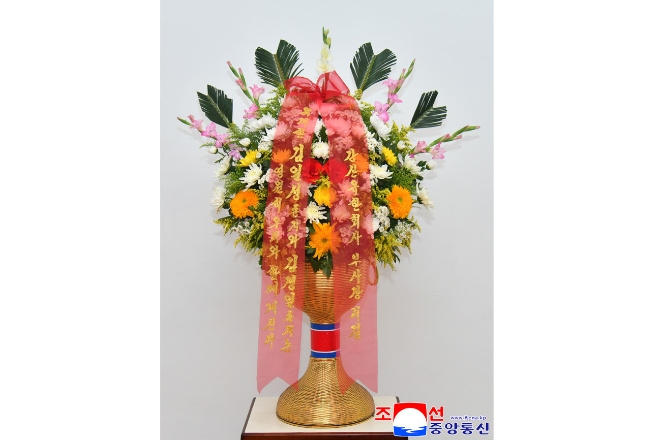 Floral baskets sent to bronze statues of great leaders Kim Il Sung and Kim Jong Il