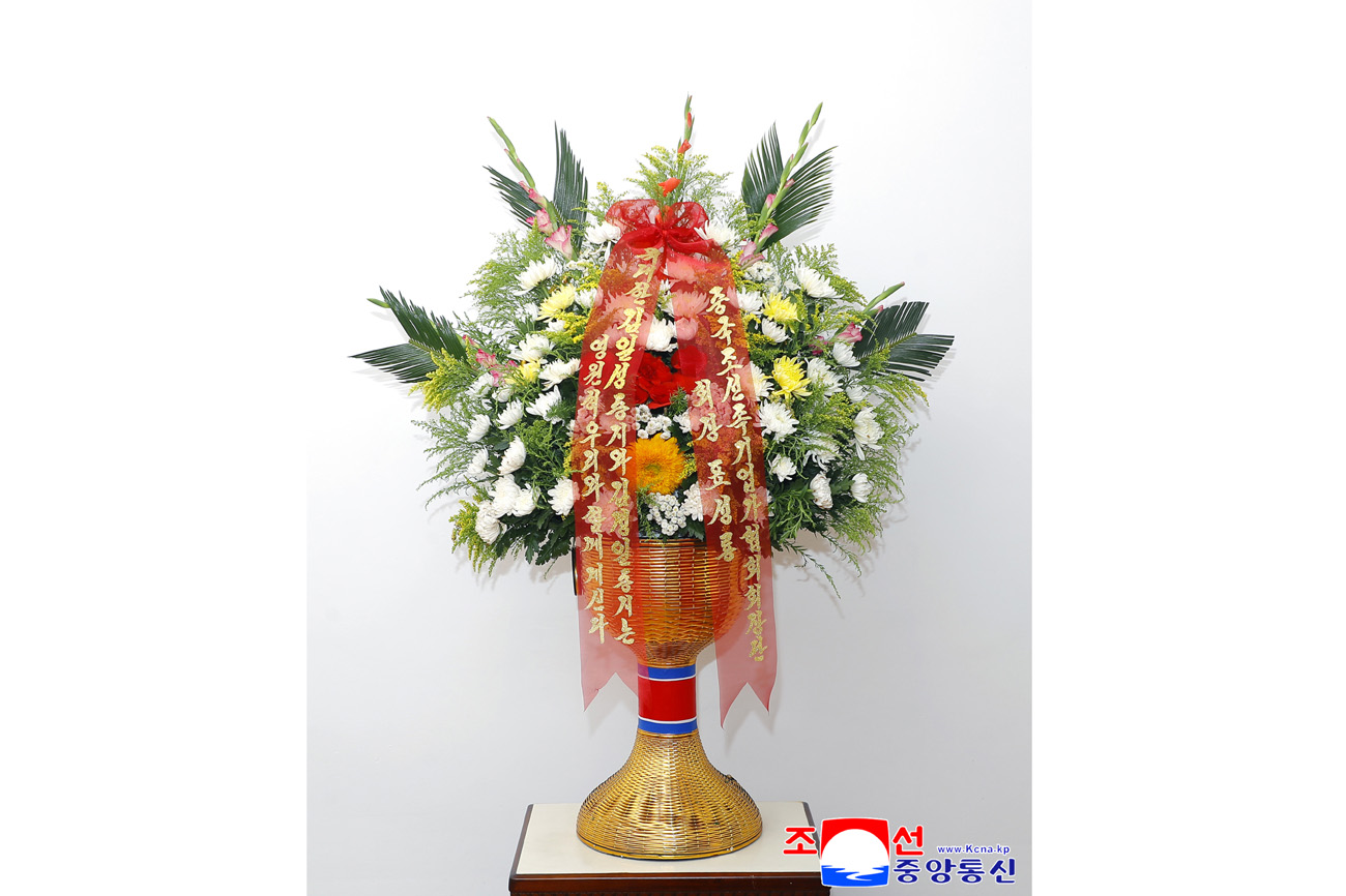 Floral baskets sent to bronze statues of great leaders Kim Il Sung and Kim Jong Il