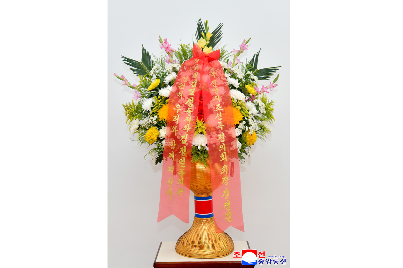 Floral baskets sent to bronze statues of great leaders Kim Il Sung and Kim Jong Il