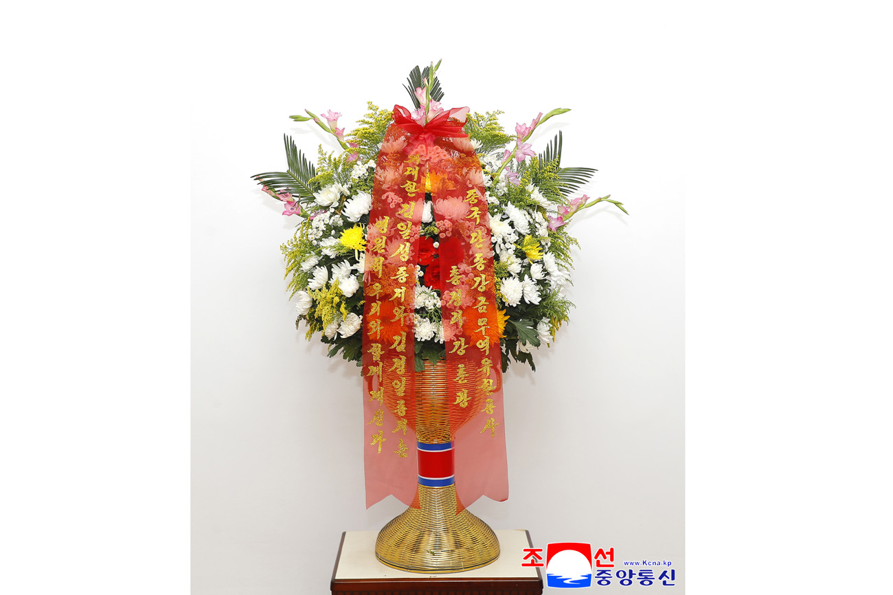 Floral baskets sent to bronze statues of great leaders Kim Il Sung and Kim Jong Il