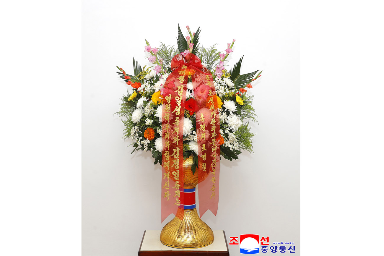 Floral baskets sent to bronze statues of great leaders Kim Il Sung and Kim Jong Il