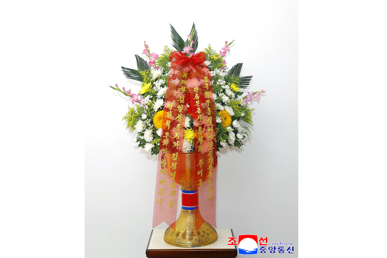 Floral baskets sent to bronze statues of great leaders Kim Il Sung and Kim Jong Il