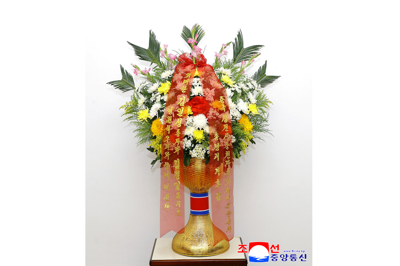 Floral baskets sent to bronze statues of great leaders Kim Il Sung and Kim Jong Il