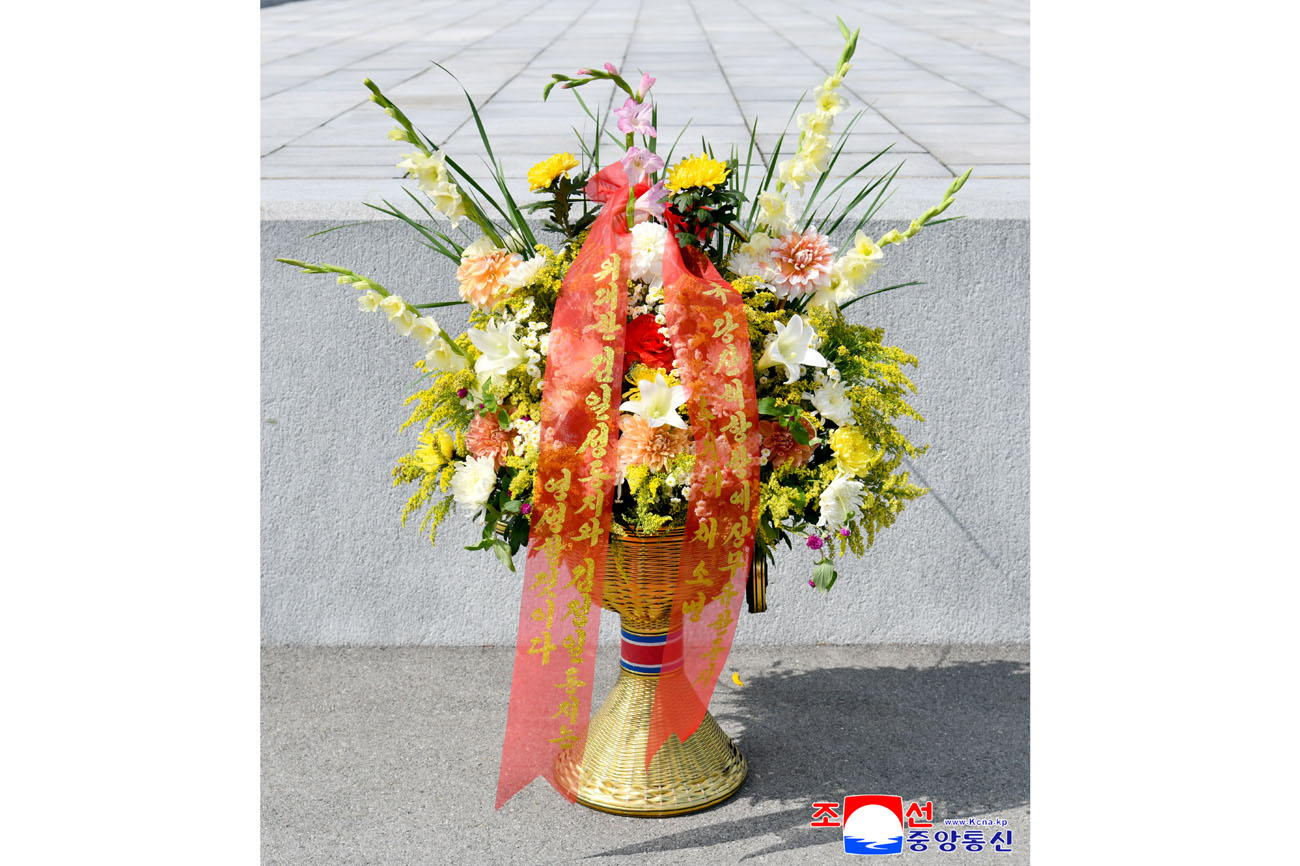 Floral baskets sent to bronze statues of great leaders Kim Il Sung and Kim Jong Il