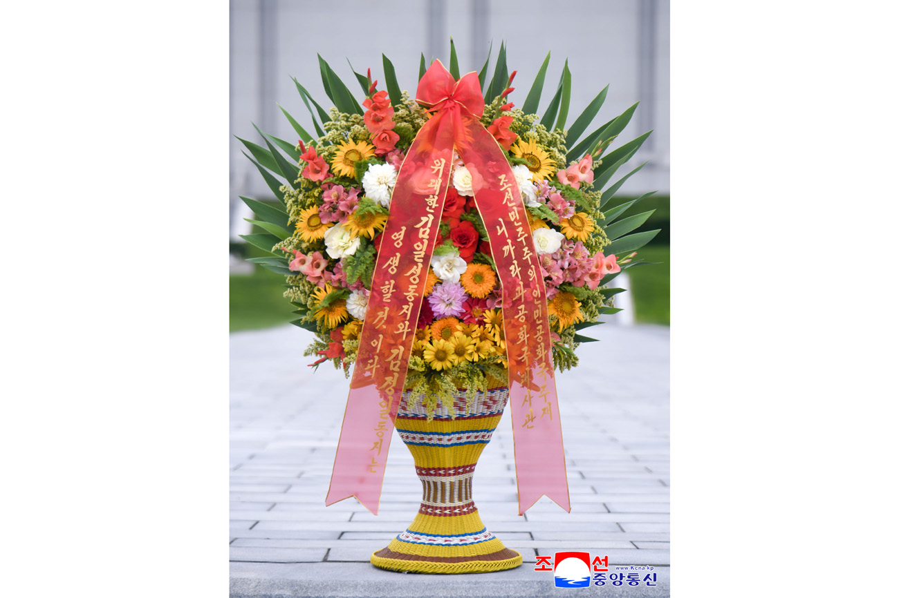 Floral baskets laid at bronze statues of great leaders Kim Il Sung and Kim Jong Il by foreign embassy staff members