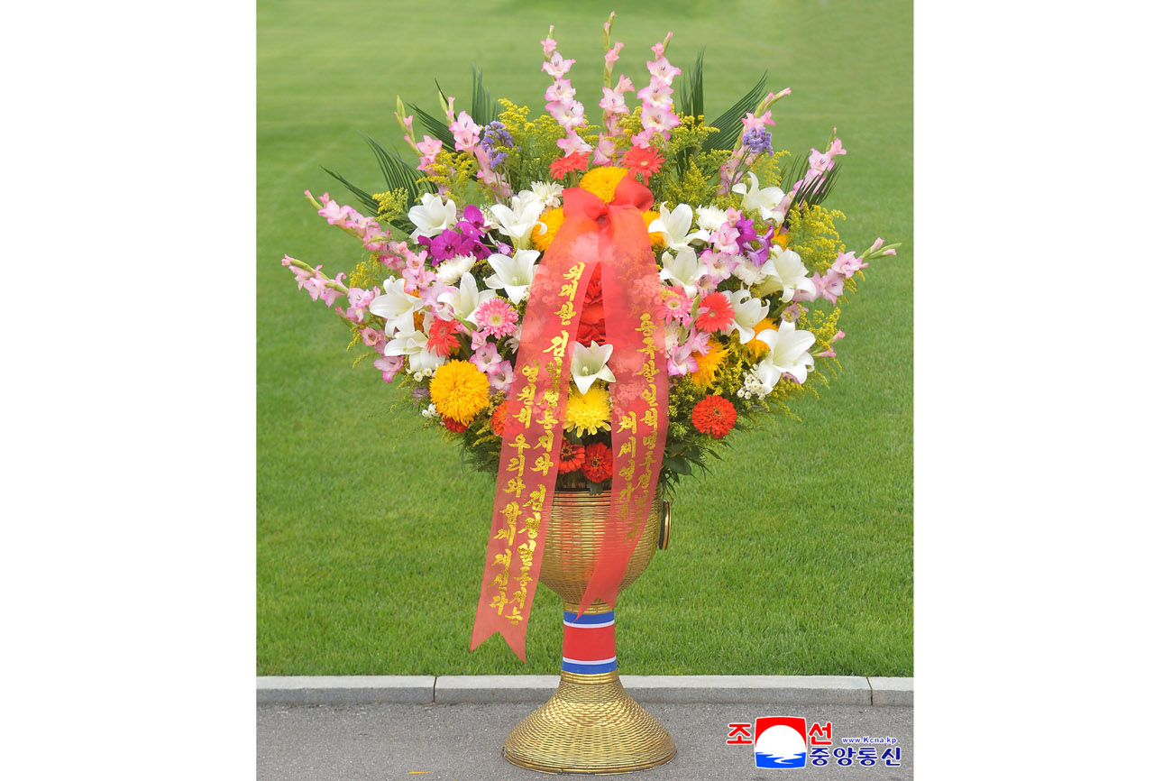 Floral baskets laid at bronze statues of great leaders Kim Il Sung and Kim Jong Il by foreign embassy staff members
