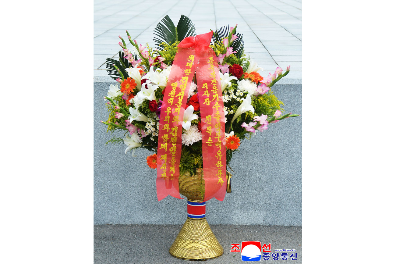Floral baskets laid at bronze statues of great leaders Kim Il Sung and Kim Jong Il by foreign embassy staff members